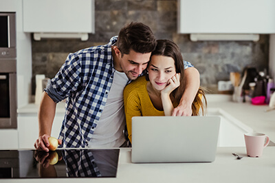 A couple using a laptop