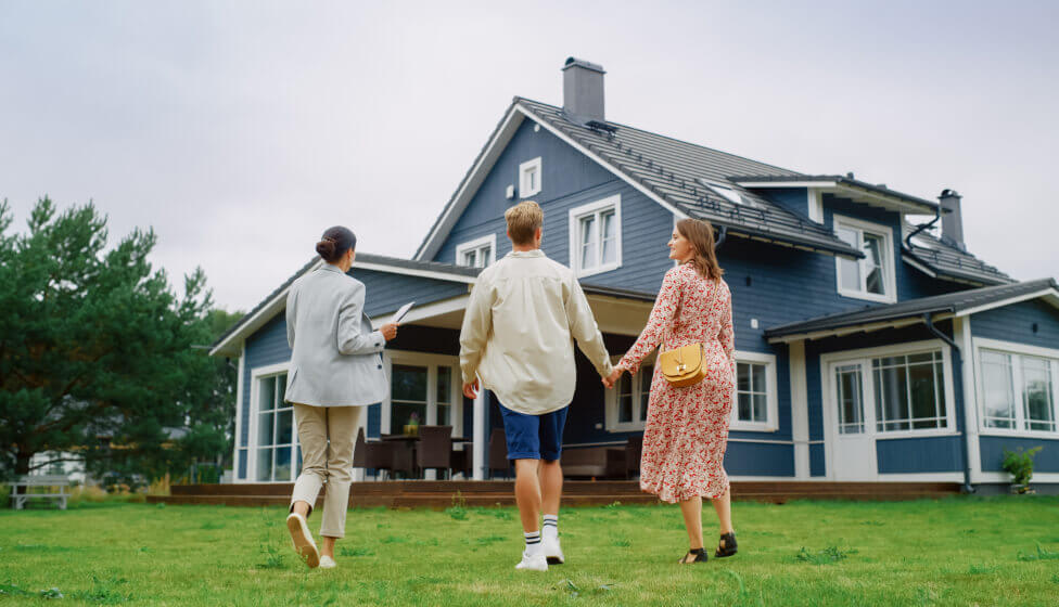 Family tours home for sale with real estate agent.