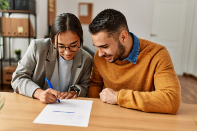 A man and a woman looking to lower their debt to income (DTI) ratio